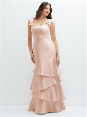 Blush pink bow-shoulder satin maxi dress with tiered asymmetrical skirt