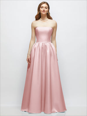 Strapless blush-pink satin gown with smooth bodice, drop waist seam, and full skirt
