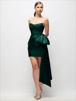 Deep green strapless satin mini dress with pleated bodice and long draped bow tail