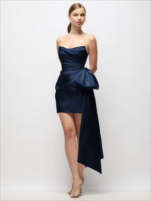Deep navy strapless satin mini dress with pleated drape and long bow tail