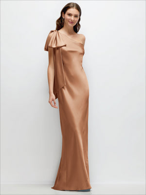One-shoulder satin maxi dress with cascading shoulder bow, copper-brown; front view.