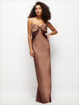 Strapless satin column maxi dress with oversized bow at bust, taupe-brown color.