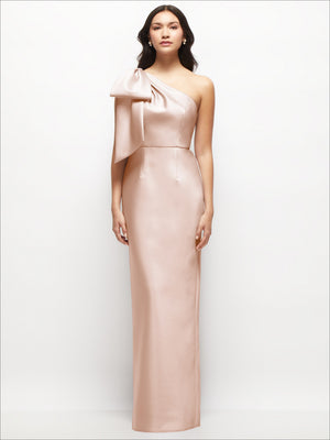 Champagne one-shoulder satin column maxi dress with oversized draped bow at neckline