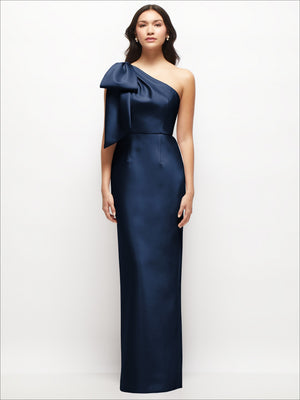 Deep navy one-shoulder satin column maxi dress with oversized bow and fitted waist