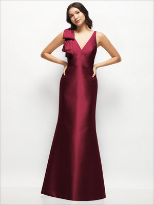 Burgundy satin trumpet dress with deep V neckline and one-shoulder cascading bow detail