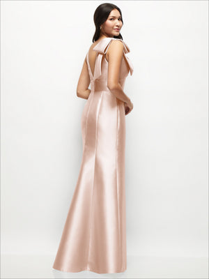 Blush satin trumpet dress with deep V-back and cascading one-shoulder bow