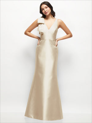 Blush satin trumpet dress with one-shoulder ruffle and V-neck front, fitted waist.