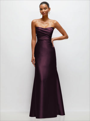 Strapless satin trumpet dress in deep burgundy with draped bodice and flared skirt.