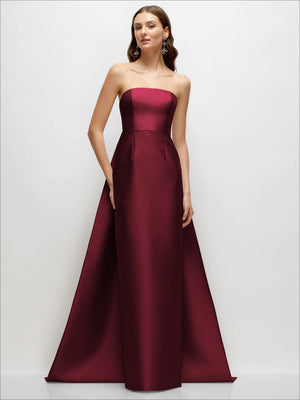 Burgundy strapless satin column dress with fitted waist and draped train