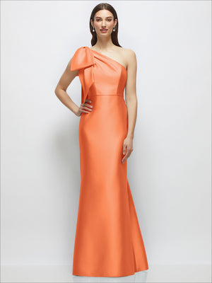 Orange one-shoulder satin maxi dress with large bow detail and trumpet skirt flare.
