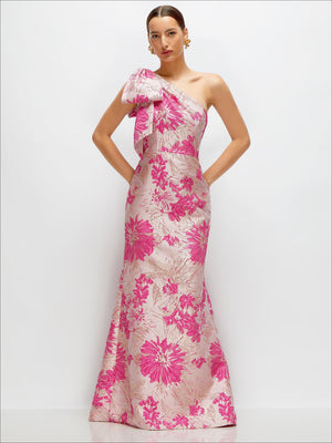 One-shoulder floral maxi dress with pink bow and trumpet hem, fitted bodice