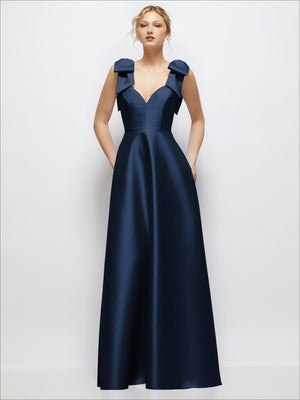 Navy satin ball gown with deep V-neckline and shoulder bow accents.