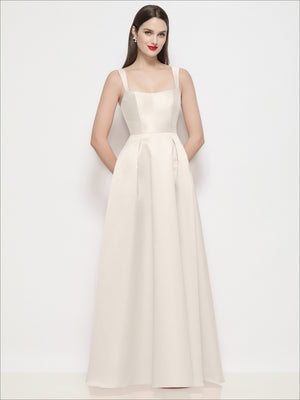 Cream satin maxi dress with shaped basque bodice, spaghetti straps, and pleated skirt.