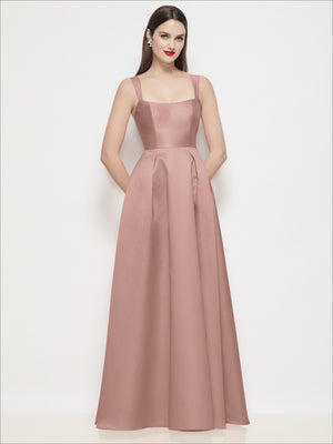 Blush satin maxi dress with shaped basque bodice, spaghetti straps, and pleated skirt.
