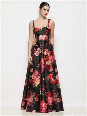 Black satin maxi dress with red-pink floral print, shaped straps, flared pleated skirt