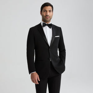 Black notch lapel tuxedo jacket with satin bow tie and white dress shirt