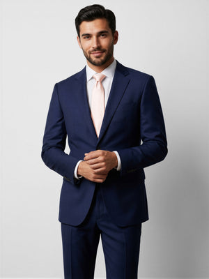 After Six narrow tie in blush pink, worn with dark blue suit jacket