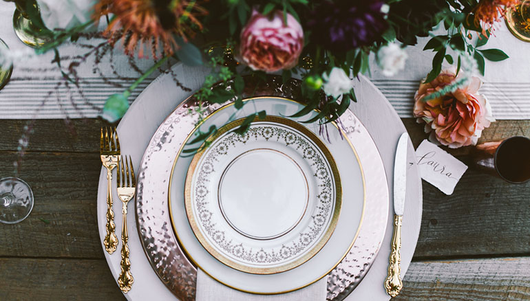 wedding place setting with gold trimmed plates