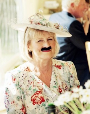 Sam Clayton photography wedding guest with fake moustache