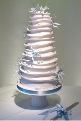 Frosty Whirl cake by Rachelles cakes white tiered wedding cake with blue flowers