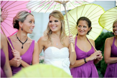via Style Me Pretty bride and bridesmaids with parasols