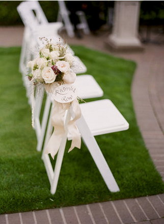Photo via Tanja Lippert Photography, flowers by Flowers Claire Marie via Project Wedding white decorated chairbacks with flowers