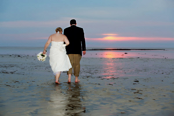 sunset wedding bride and groom with beach sunset