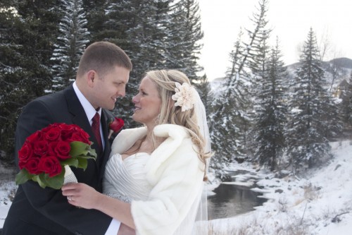 bride and groom in the snowy with red rose wedding bouquet bride and groom in the snow