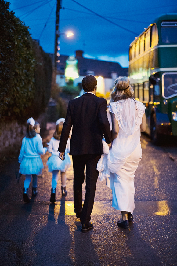 bride and groom walking with bridesmaids