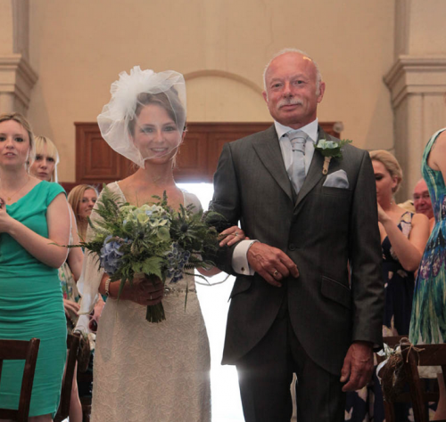 bride walking down aisle with father