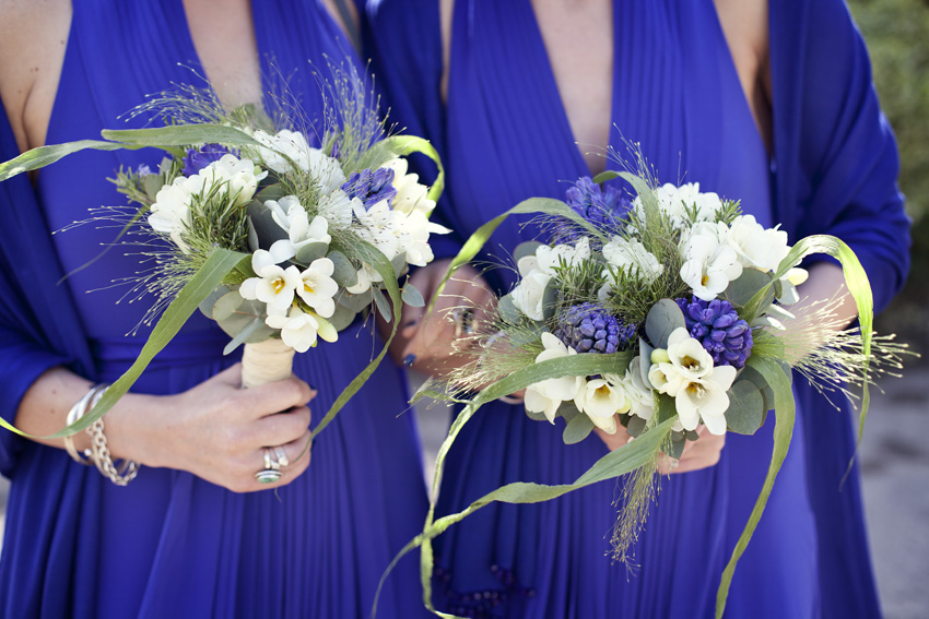 bridesmaids in blue dresses with bouquets
