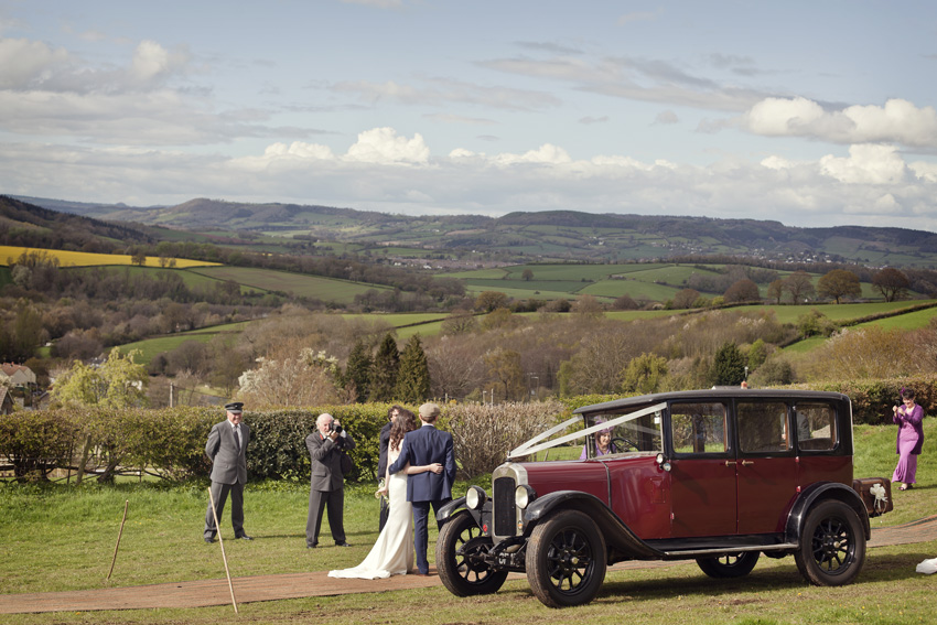 bride and groom at reception in classic car