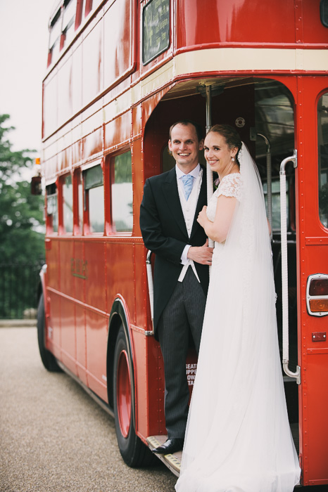 bride and groom on red London double decker bus