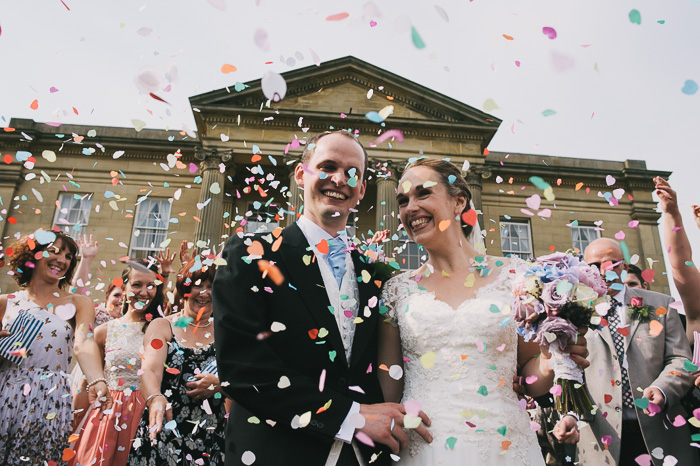 bride and groom covered in confetti